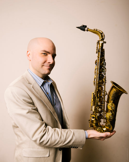 Rulon Brown holding a Mark VI alto saxophone in his hand