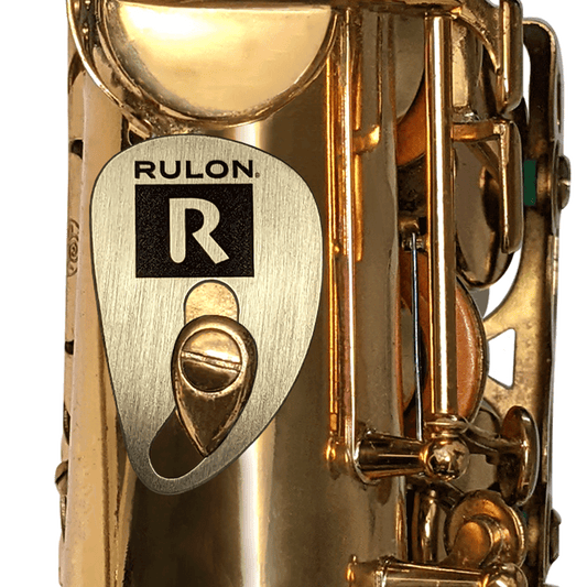 Raw brass saxophone rest designed by RULON BROWN. It replaces the right thumb hook of the saxophone and is adjustable to fit any hand size comfortably.