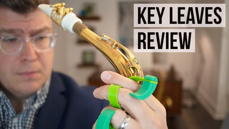 An image of a saxophone player holding his saxophone and Key Leaves sax key props, with the text "Key Leaves Review"