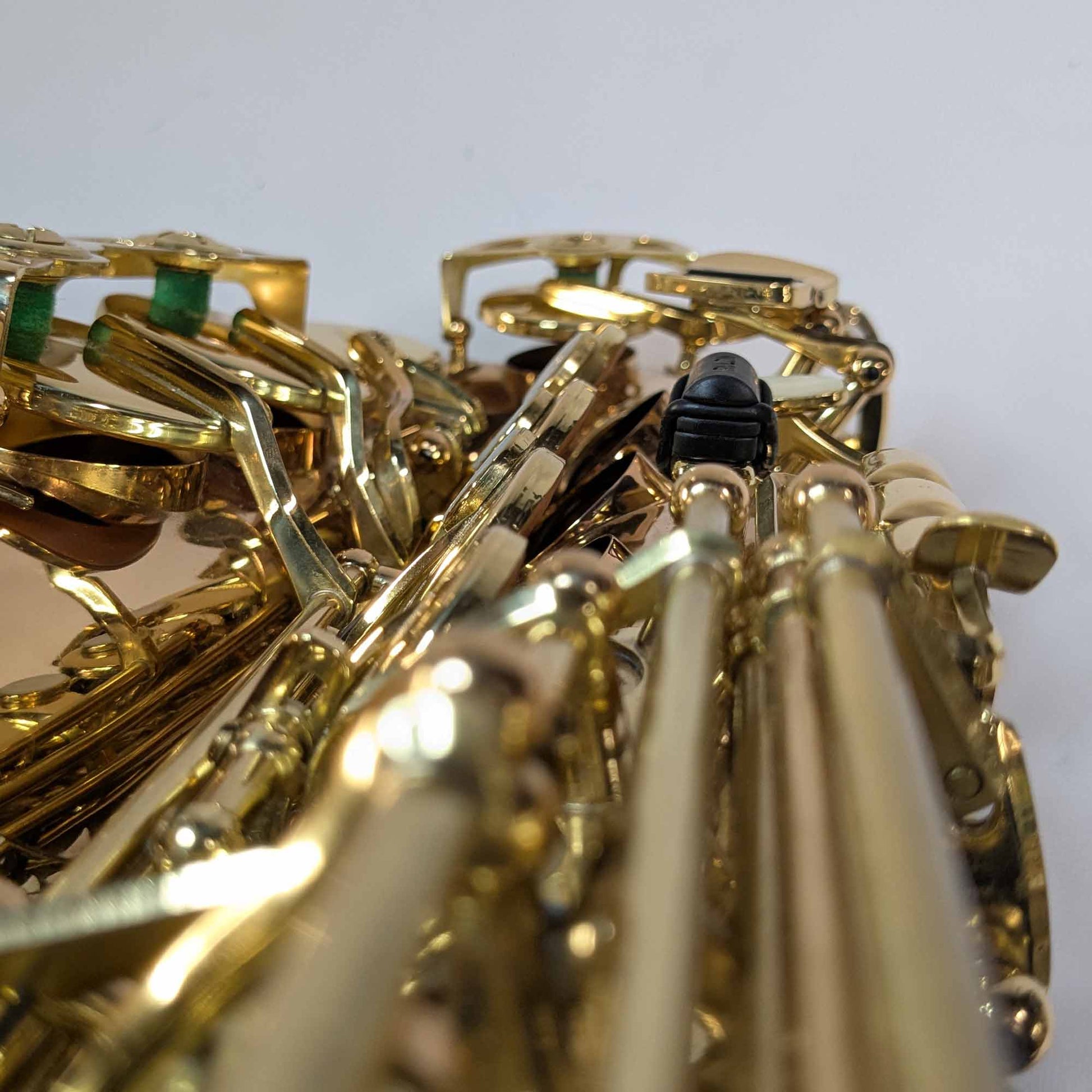 The RULON Saxophone Key Booster for High F Sharp, shown looking down the sax keys of the right hand.