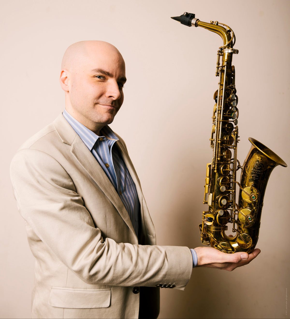 Rulon Brown holding an alto saxophone