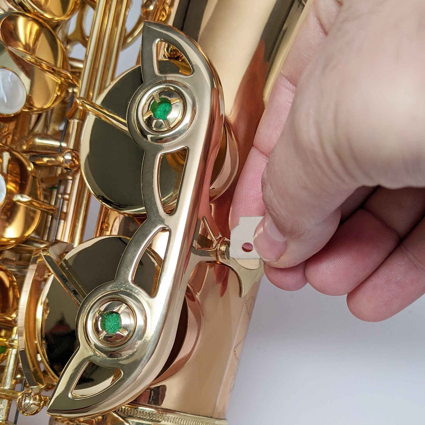 RULON Fingertip Screwdriver being used to adjust a alto saxophone key guard screw. 
