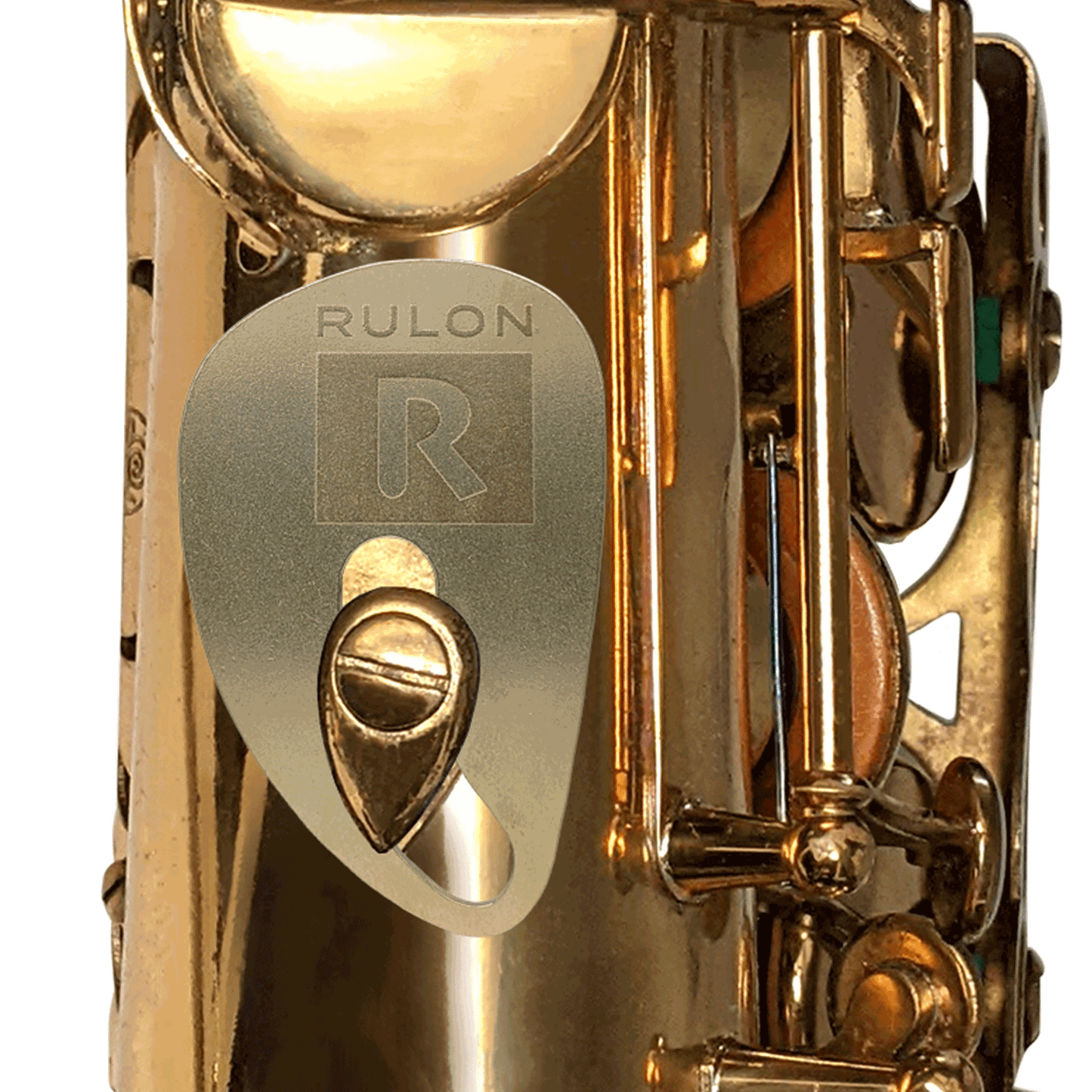 A RULON Saxophone Rest made from tumbled raw brass shown mounted to a tenor saxophone thumb hook screw.